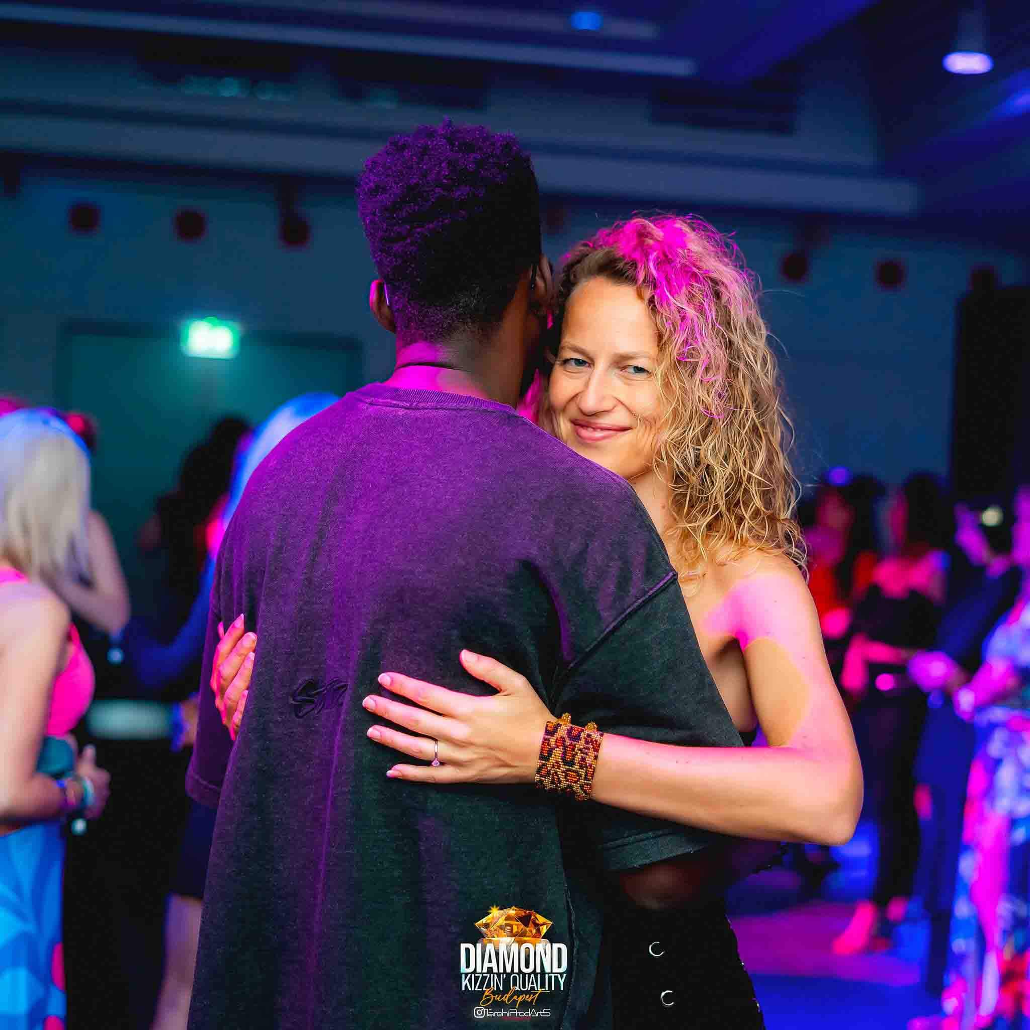 Dancing with a student during a social event.